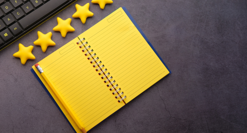 How Learners Assess if Your Online Executive Education Will Give a Good ROI - an open notebook on a desk with five yellow stars above it
