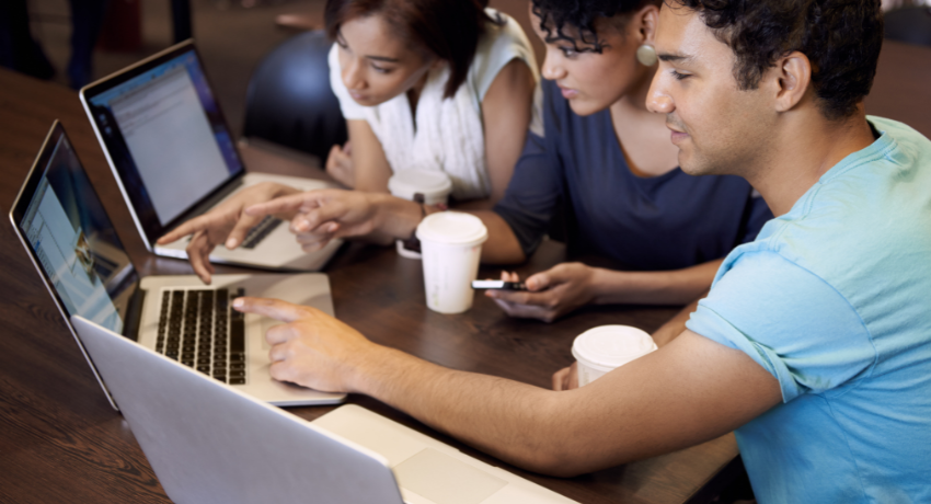 Online Learning The Ultimate Guide 2023 - a group of young people sit in front of three laptops collaborating on a project